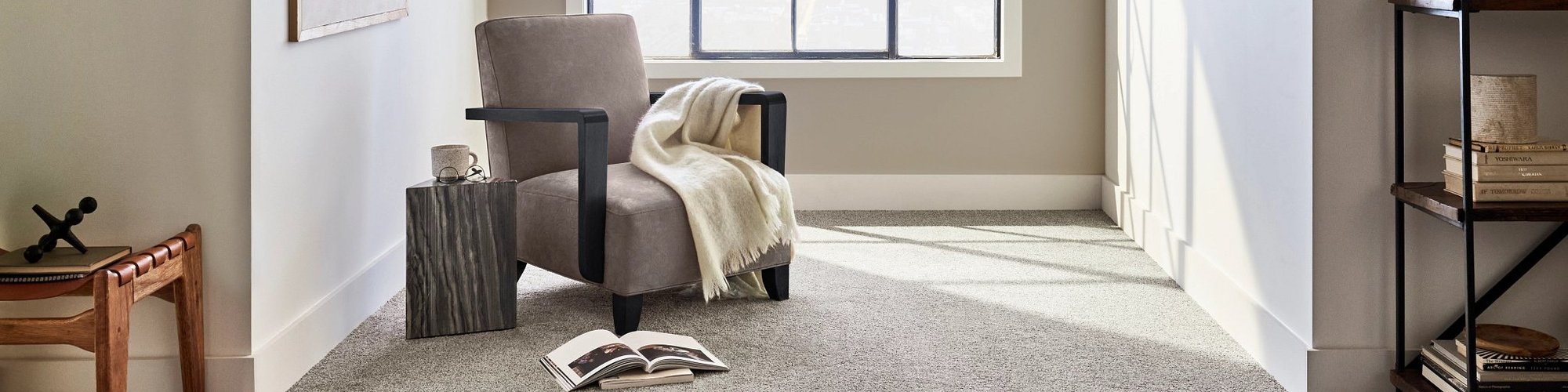 room with carpet, chair and books on the floor